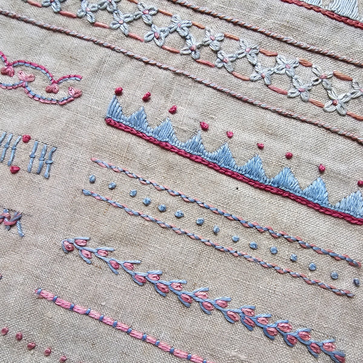 Rare and unusual embroidery sampler in blue and pink