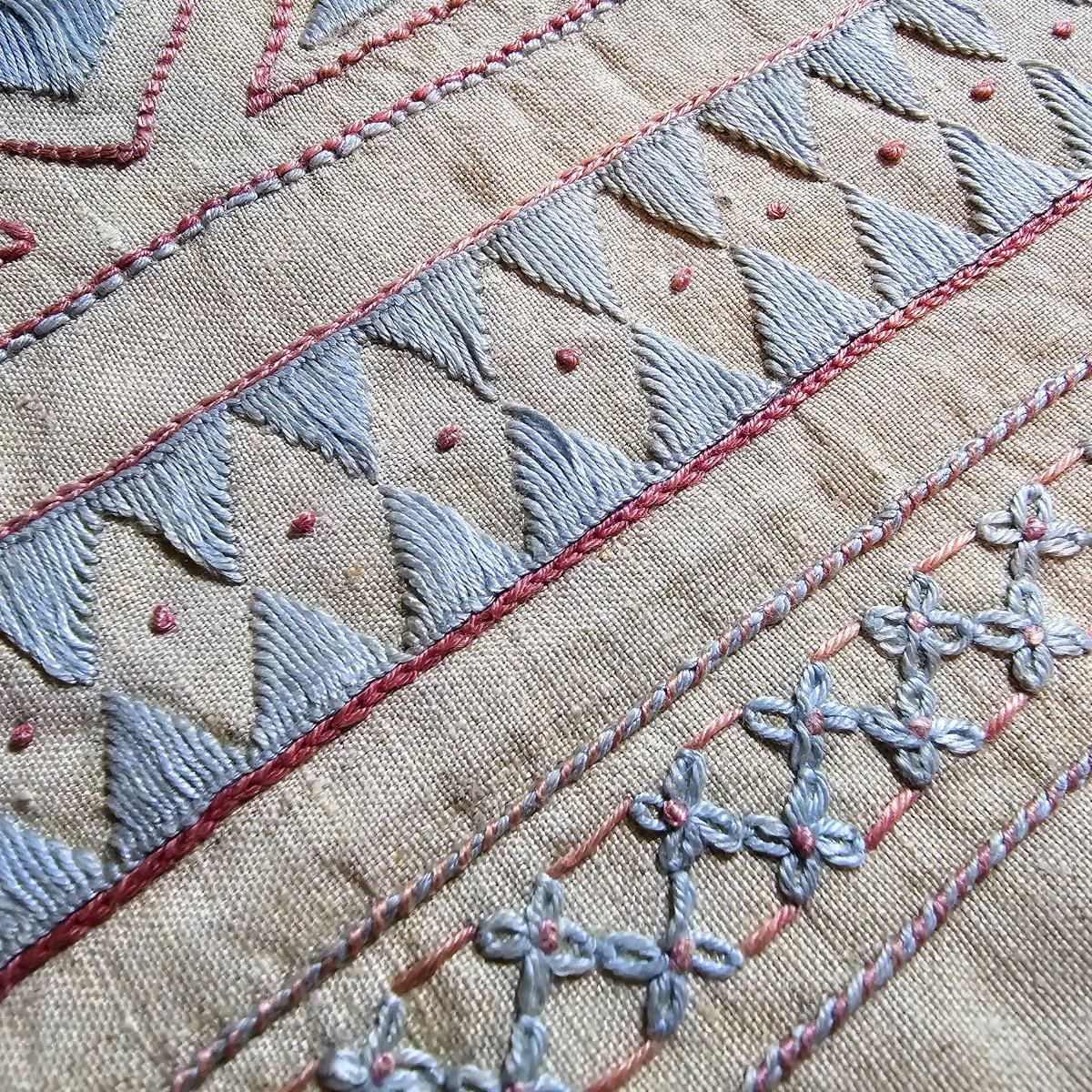 Rare and unusual embroidery sampler in blue and pink