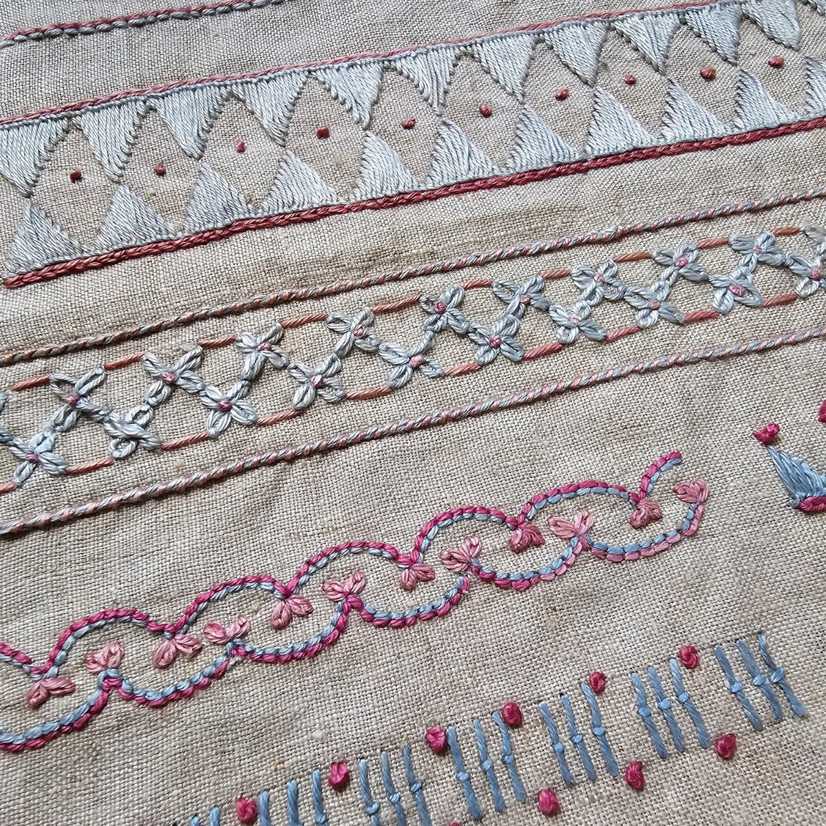 Rare and unusual embroidery sampler in blue and pink