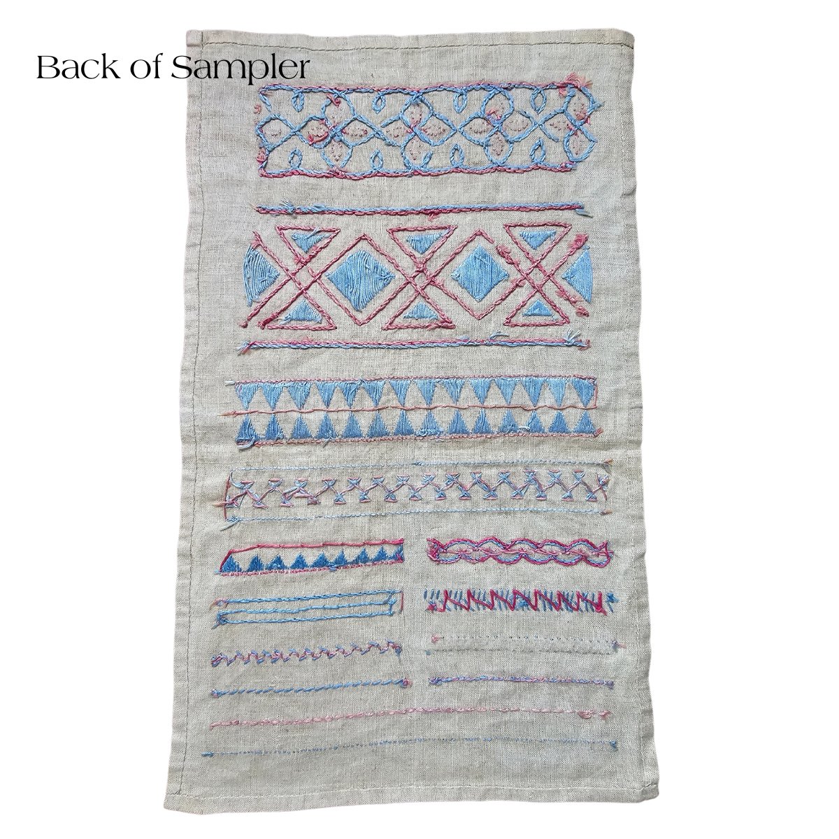 Rare and unusual embroidery sampler in blue and pink