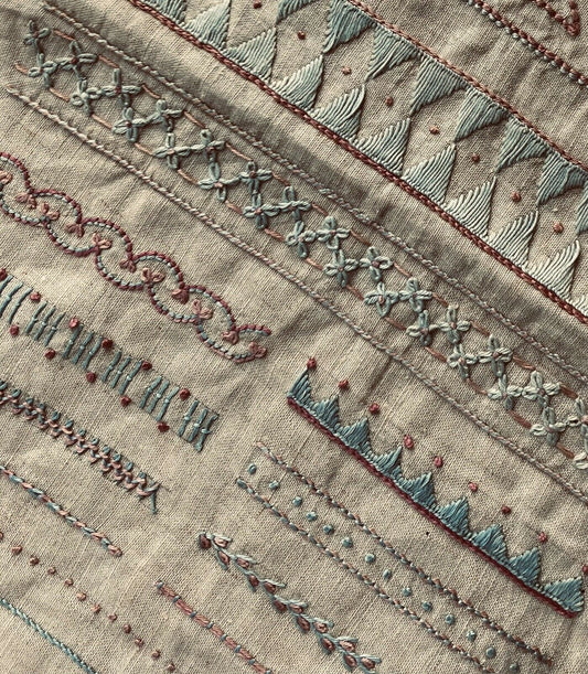 Rare and unusual embroidery sampler in blue and pink